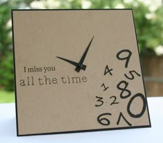 a clock with the words i miss you all the time written in black on it