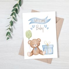 a welcome baby card with a teddy bear holding a balloon and a gift box on it