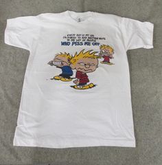 "Vintage, color Calvin and Hobbes novelty phrase t shirt. Rare and collectible! Would look great as part of 90s streetwear ensemble. Note small stain on collar. Approximate dimensions: 26\" neck to bottom seam x 20\" armpit-to-armpit" Casual Graphic Print T-shirt For Fan Conventions, Fun Graphic Print Tops For Fan Conventions, 90s Style Funny Print T-shirt For Streetwear, Vintage Graphic T-shirt For Fan Conventions, Vintage Graphic Print T-shirt For Fan Conventions, 90s Style Screen Print T-shirt For Fan Conventions, Vintage Screen Print T-shirt For Fan Conventions, Vintage Funny Print Tops For Streetwear, Funny Front Print Top For Streetwear