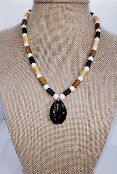 Please tap the link below to view my other BOHO jewelry products. www.etsy.com/shop/transcendenceboho COWRIE SHELL NECKLACE ITEM DETAILS Black, tan and beige wood beads with white glass beads and painted black cowrie shell charm. This is a unisex necklace which can be worn either as a causual or dressy accessory.  This necklace has a subtle chicness that is fun to wear whether at rest or at play. This necklace can be purchased with or without the shell. NECKLACE LENGTH = 16 inches; length adjust Bea Alonzo, Mens Choker Necklace, Beach Hippie, Shell Beads Necklace, Moda Hippie, Cowrie Shell Necklace, Beaded Bead, Caribbean Beach, Shell Choker