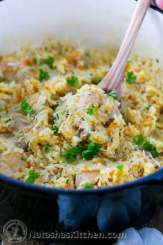 a blue pot filled with rice and meat