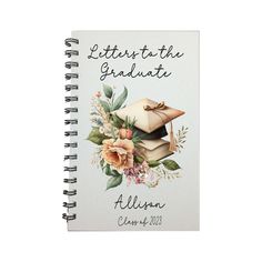 a spiral notebook with the words, letters to graduate written on it and flowers in front