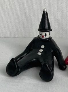 two black and red ceramic figurines sitting next to each other