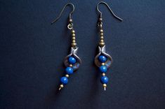 Loops made on brass wire with white metal findings where lapis lazuli beads and small brass beads have been threaded. Unique piece. Blue Beaded Dangle Earrings In Brass, Blue Beaded Brass Dangle Earrings, Blue Dangle Beaded Brass Earrings, Blue Beaded Brass Earrings, Blue Brass Beaded Dangle Earrings, Handmade Lapis Lazuli Bohemian Earrings, Blue Beaded Brass Earrings With Ear Wire, Blue Brass Beaded Earrings With Ear Wire, Blue Beaded Brass Earrings As Gift