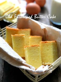 old fashioned butter cake in a basket on a table with eggs and milk behind it