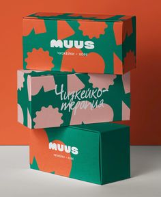 three boxes stacked on top of each other in front of an orange and green background