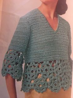 a woman wearing a green crochet top with holes