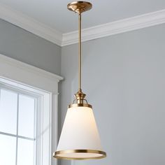 a light fixture hanging from the ceiling in a room with gray walls and white trim