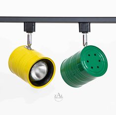 two green and yellow lights hanging from the ceiling