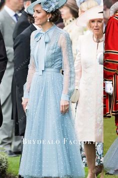 the royal family are all dressed up in blue dresses and hats for an official event