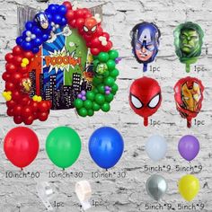 various balloons and masks are on display against a brick wall with the names of each balloon