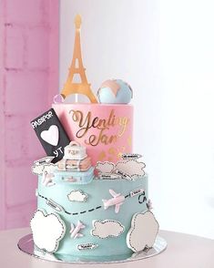 a multi layer cake with the eiffel tower in the background