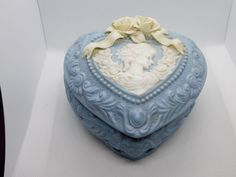 there is a blue heart shaped box with a woman's face on it