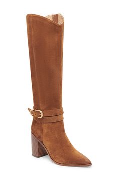 A buckled strap wraps around the ankle of a knee-high boot balanced by a pointy toe and stacked block heel. 3 1/4" heel Side zip closure with elastic gore inset Leather upper/synthetic lining and sole Made in Brazil Knee-high Boots With Buckle Closure For Work, Brown Knee-high Boots With Buckle For Work, Brown Buckle Closure Knee-high Boots For Work, Heeled Boots With Buckle Ankle Strap, Wide Calf Heeled Boots With Buckle For Work, Wide Calf Heeled Boots With Buckle Closure For Work, Wide Calf Boots With Buckle Closure For Work, Fall Ankle Strap Workwear Boots, Fall Workwear Ankle Strap Boots