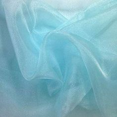 a close up shot of the fabric on a bed sheet that is very soft and light blue