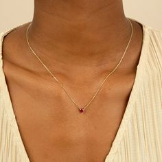 Corin Ruby is a stone of royalty, highly coveted for its rich red hue. This ruby was meticulously cut into the most subtle of hearts so you can wear it every day. It layers well with other dainty necklaces, and alone it almost looks like it is floating on your neck. This is the perfect gift for a girlfriend, daughter, granddaughter or even bridesmaid. - Handmade- Solid Gold- Natural Ruby- Pendant Size: 5 mm- Total Ruby Carat Weight: 0.40 ctw All Sarah Elise ruby jewelry come beautifully boxed in Gold And Ruby Ring, Ruby Heart Necklace, Gold Gemstone Necklace, Ruby And Diamond Necklace, Diamond Pendants Designs, Ruby Heart, Dainty Necklaces, Ruby Birthstone, Diamond Pendants