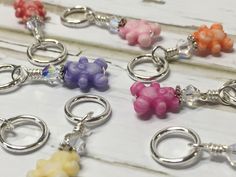 several key chains with different colored teddy bears on them and charms attached to each one