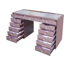 a pink desk with many drawers on it