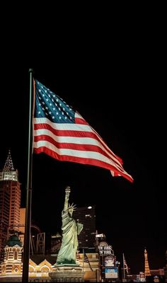 the statue of liberty is lit up at night