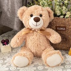 a brown teddy bear sitting next to a basket with flowers