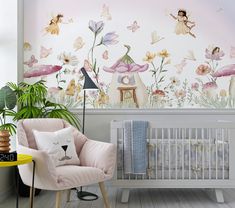 a baby's room decorated in pink and white with fairy themed wallpapers