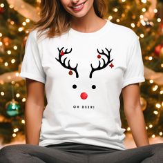 "Step into the festive spirit with our \"Oh Deer\" Reindeer Tee Shirt - the perfect blend of holiday cheer and trendy style for free-spirited souls!  No side seams mean there are no itchy interruptions under the arms. The shoulders have tape for improved durability. .: Made with medium fabric (5.3 oz/yd² (180 g/m consisting of 100% cotton for year-round comfort that is sustainable and highly durable.  .: The tear-away label means a scratch-free experience with no irritation or discomfort whatsoe White Casual Christmas T-shirt, Casual White Christmas T-shirt, White Casual T-shirt For Christmas, Casual White T-shirt For Christmas, White Winter Tops As Gift, White Winter Tops As Gifts, White Winter Tops For Gifts, White Winter Tops As A Gift, New Year Gift Crew Neck T-shirt