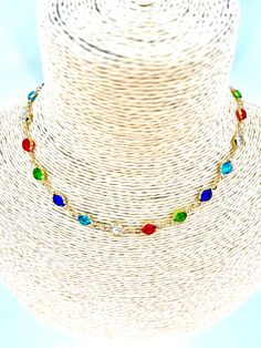 A colourful crystal gold chain choker, the perfect accessory to add a pop of colour and vintage charm to any outfit. Made for women who love to express their unique style, this boho-inspired choker features a beautiful combination of colourful crystals and a stunning gold chain.  Key Features: - Boho vintage design: The colourful crystal gold chain choker is designed to capture the essence of bohemian style with its vintage-inspired design. - High-quality materials: Made with premium materials, Bohemian Crystal Choker Necklace For Party, Multicolor Chain Choker Jewelry, Adjustable Crystal Choker Chain Necklace, Multicolor Clavicle Chain Choker As Gift, Gold Crystal Necklace With Delicate Chain For Parties, Multicolor Crystal Beaded Chain Necklace, Multicolor Crystal Jewelry With Chain, Multicolor Crystal Chain Jewelry, Party Gold Crystal Necklaces With Colorful Beads