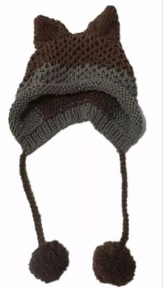 a knitted hat with two pom poms on the brim and one ear flap