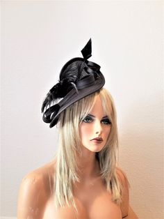 This is a black Sinamay Fascinator with feather flower and duck spike sits on a matching satin headband or clip both included. Ships immediately expect 4-6 business days. Fitted Black Top Hat For Formal Occasions, Black Fitted Top Hat For Formal Occasions, Formal Black Fitted Top Hat, Formal Fitted Black Top Hat, Black Fitted Fascinator For Party, Fitted Black Fascinator For Party, Elegant Party Costume Hats And Headpieces With Feather Trim, Elegant Top Hat For Kentucky Derby Costume Party, Elegant Black Feather Trim Costume Hat