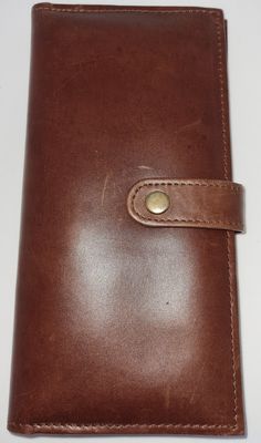 This Cow Grain Leather Handmade Long Wallet in Brown (CW411) is a perfect mix of vintage and modern style. The wallet features a solid pattern with velvet fabric that adds a touch of luxury. It has a bifold design with a button accent that secures your essentials. The wallet has a dimension of 20 cm in length and 10 cm in width, making it a perfect fit for your pocket. What sets this wallet apart is its functionality. It includes RFID blocking technology that protects your credit cards from any Vintage Brown Wallet For Travel, Vintage Brown Travel Wallet, Vintage Brown Wallets With Leather Lining, Vintage Brown Wallet With Leather Lining, Vintage Wallets With Coin Pocket For Business, Vintage Brown Wallets For Daily Use, Vintage Brown Bifold Wallet For Daily Use, Vintage Brown Wallets With Card Slots For Daily Use, Vintage Brown Wallet With Card Slots For Daily Use