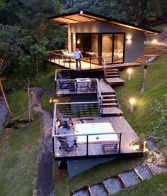 the house is built on stilts and has stairs leading up to it's roof