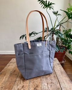 This versatile, fun tote is our best selling go-to for daily carry. Small batch handmade in our Omaha, NE studio using sturdy water repellent duck canvas and American full grain leather. Large Capacity Duck Canvas Bag For On-the-go, Waxed Canvas Bag With Leather Handles For On-the-go, Double Handle Canvas Bag For On-the-go, Practical Duck Canvas Bags For Everyday Use, Green Canvas Bag With Leather Handles For On-the-go, Casual Double Handle Waxed Canvas Bag, Everyday Canvas Bag With Duck Canvas Lining, Duck Canvas Bag With Leather Handles For Everyday Use, On-the-go Canvas Bag With Reinforced Handles