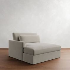 a white couch sitting on top of a wooden floor