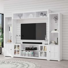 a white entertainment center with bookshelves and a flat screen tv