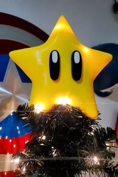 a star shaped light up decoration on top of a christmas tree