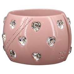 Chanel 2004 pale dusty rose acrylic clamper cuff with inlaid faceted silver-backed heart crystals, a geometric design featuring double rows of intersecting inlaid mini-crystals and two CC logos inlaid with mini-crystals at the bottom of each side. In excellent condition with 1-2 almost imperceptible nicks to the surface. DIMENSIONS: Height - 2.25" Diameter (at the interior) - 6.75" Outer Diameter - 9.875" Chanel Cuff, Bracelet Heart, Heart Motif, Rose Pale, Dusty Rose Color, Pink Chanel, Rhinestone Bracelet, Leather Fringe, Crystal Heart