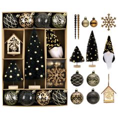 an assortment of christmas ornaments and decorations in wooden boxes with gold, black and white accents