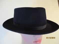 This is a black felt trilby with a black band, made by Fletchet.  Inside is a brown leather hat band,  very good condition. Size;  57 \ 5 Height;  4"  10 cm Width;  12.5 X 11.5  32 cm  X 28 cm Diameter inside head;  22"   56 Made by FLETCHET in France Felt Classic Black Flat Cap Felt Hat, Classic Formal Flat Cap Felt Hat, Adjustable Formal Felt Flat Cap, Black Fitted Flat Cap Felt Hat, Fitted Formal Flat Cap Felt Hat, Classic Black Felt Hat For Formal Occasions, Formal Winter Flat Cap Felt Hat, Formal Winter Felt Flat Cap, Winter Formal Felt Flat Cap