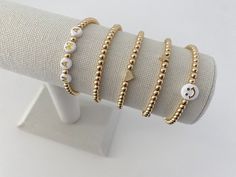 >> Product Details NEW* This listing has been upgraded from metallic plastic beads to 14k gold plated beads! * (1) 4mm 14k gold plated bracelet * These bracelets are made with a standard size of 7 inches -- *PLEASE NOTE: if you would like the opening smaller/larger, this needs to be noted within the personalize box at checkout. I can make these to whatever size you would like! However, they will come in the standard size unless otherwise stated at checkout. * Listing includes ONE bracelet. Trendy Stackable Jewelry For Friendship, Trendy Customized Gold Jewelry, Customized Trendy Gold Jewelry, Trendy Gold Charm Bracelet With Letter Beads, Adjustable Yellow Gold Trendy Charm Bracelet, Adjustable Trendy Yellow Gold Charm Bracelet, Trendy Gold Beaded Bracelets, Trendy Adjustable Yellow Gold Charm Bracelet, Trendy Yellow Gold Beaded Bracelets For Gift