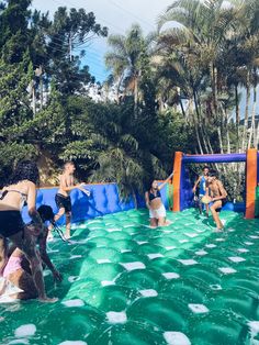 people are playing in the pool with water toys