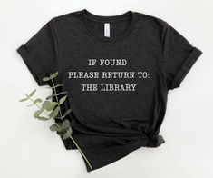 If found please return to the library! The perfect shirt for book lovers and librarians! MATERIAL This t-shirt is everything you've dreamed of and more. It feels soft and lightweight, with the right amount of stretch. It's comfortable and flattering for both men and women.  ✨ Shirt sizes are Unisex, please refer to sizing chart in listing photos ✨ 100% combed and ring-spun cotton  ✨ Medium fabric weight CARE ✨ Machine wash: warm (max 40C or 105F) ✨ Do not iron ABOUT My love for design and clothi Library Tshirt, Bookish Pictures, Book Camp, Librarian Tshirt, Bookish Shirts, Librarian Tshirts, Author Aesthetic, Book Merchandise, Library Shirt