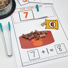 a table topped with lots of different types of dog food next to scissors and measuring tape