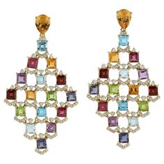 These multi gemstone earrings are handmade in 18 Karat gold. It is beautifully detailed with 19.95 carats amethyst, citrine, garnet, peridot, topaz and 1.39 carats of sparkling diamonds. FOLLOW MEGHNA JEWELS storefront to view the latest collection & exclusive pieces. Meghna Jewels is proudly rated as a Top Seller on 1stdibs with 5 star customer reviews. All items manufactured by us are handmade and can be customized or redesigned. Composition Size-57X30 MM Total Weight-22.81 Gold Weight(Gms Diamond Dangle Earrings, Art Deco Diamond, Blake Lively, Sparkle Diamonds, Diamond Gemstone, Chandelier Earrings, Gemstone Earrings, Earrings Handmade, Citrine