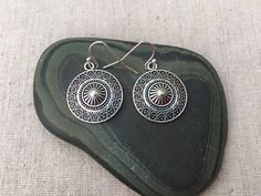 "These are unique and highly detailed boho disc earrings. They have a unique eye catching design and would be perfect for everyday wear. They measure 7/8\" across by 1\" long and hang from simple elegant ear wires. The earrings are made from allergy free plated silver. I have a matching necklace in my shop, if you would like the whole set. Here is the link https://etsy.me/2X6CB2r Thanks for stopping by. Please take a moment and visit the rest of my shop. I have many more unique jewelry designs t Round Festival Earrings, Southwestern Metal Earrings For Gift, Southwestern Style Metal Earrings For Gift, Bohemian Circle Earrings With Ear Wire, Adjustable Round Bohemian Plug Earrings, Southwestern Style Festival Earrings, Southwestern Style Round Festival Earrings, Southwestern Style Festival Round Earrings, Circular Festival Earrings With Hooks