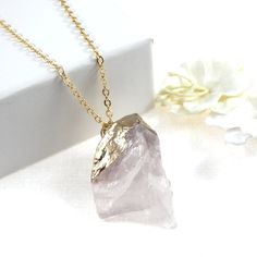 "These elegant 100% natural rose quartz gemstones have been accented by a shimmering gold filled chain. Select your very own gemstone from the final photo, making each and every piece a true one of a kind. The top of each of the rose quartz have been electro plated for an elegant finishing touch. Select either a 42cm ( 16 1/2\" ) or 46cm ( 18\" ) gold filled or gold plate chain from the drop down menu at the moment of checkout. Each of my items arrive in a signature white gift box ready to give. Gold Jewelry With Large Stone For Gift, Gold Rose Quartz Jewelry For Jewelry Making, Gold Amethyst Necklace With Raw Stone, Gold Rose Quartz Pendant Jewelry, Rose Quartz Gemstone Gold Jewelry, Gold Rose Quartz Gemstone Jewelry, Gold Rose Quartz Jewelry Gift, Gold Crystal Necklace With Raw Stone For Gifts, Gold Crystal Necklace With Raw Stone As Gift