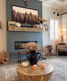 a living room filled with furniture and a large painting on the wall above a fire place