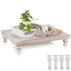 a wooden table topped with a plant and beads