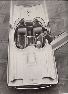 an overhead view of a car with the door open and two people in it's seat