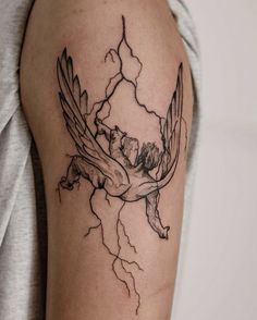 a woman's arm with a tattoo on it that has a bird and lightning