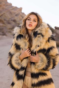 WOMEN’S DESERT WARRIOR COAT FEATURES High quality faux fur. Lined with super soft cuddle minky fabric. Over sized fur lined hood and large lapel. 2 Deep zipper pockets on the inside front sides (large enough for a water bottle). 2 Outside pockets to keep your hands warm. 6" Invisible zipper ID "secret" pocket on the inside left chest lining. 3 Outside button closures. Inside back pack straps to wear the coat like a cape when you are hot. Length is shorter in the back around the knee, longer in t Desert Warrior, Festival Coats, Sequin Vest, Rave Babe, Winter Outfits Aesthetic, Secret Pocket, Cozy Coats, Winter Festival, Cold Weather Fashion